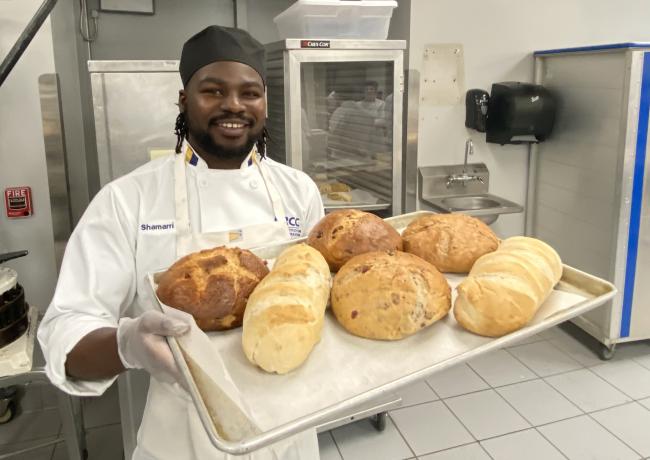 Shamarri Key showing different types of bread baked in his class.