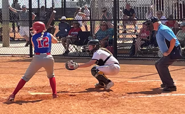GRCC softball player catching behind the plate.