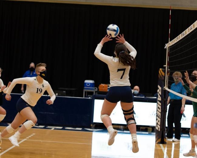 A GRCC volleyball player prepares to set up another for a spike.