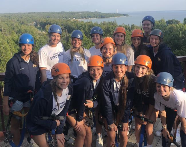 Volleyball team members in St. Ignace before riding a zip line. 