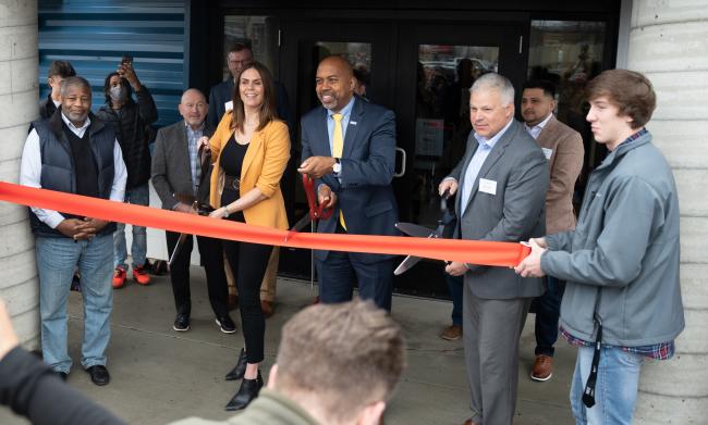GRCC President Pink and WMCI leaders about to cut the ribbon for new facility.