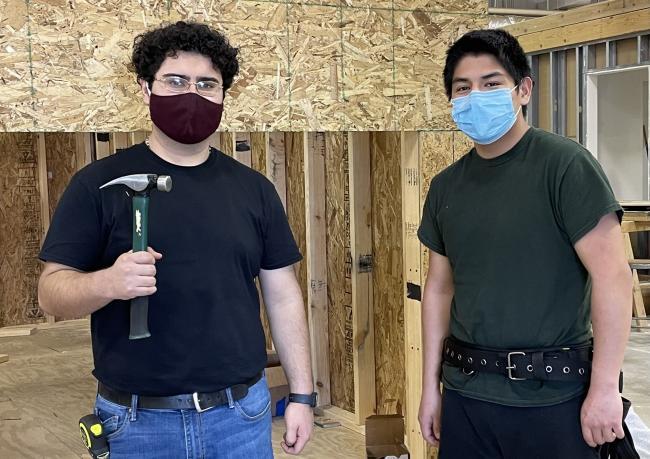 Kenneth Lara and Francisco Mendez in the construction classroom with tools.