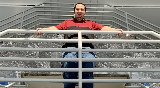 Mathew Majestic looking down from a railing.