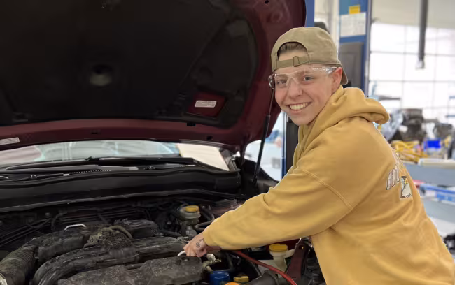 Sophia Lonnee working on a car. 