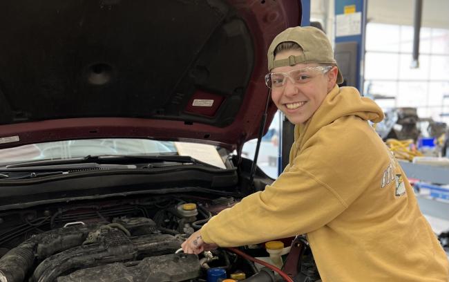 Sophia Lonnee working on a car. 