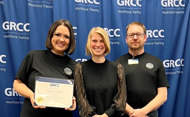 Sydney Sayre with instructors Bri Lampe and Nick Pinkney.