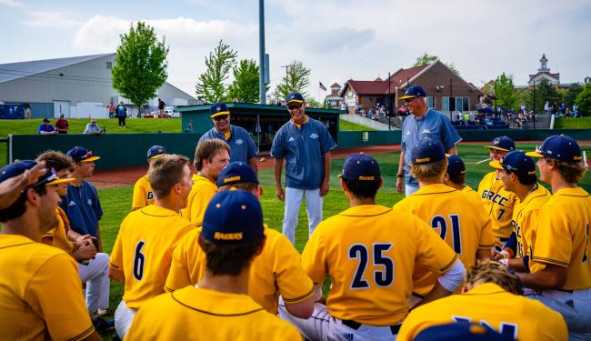Baseball team listening to the coaches prior to a game.
