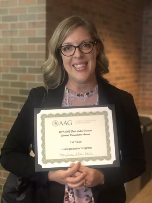 MaryAnne Flier holds up her first-place certificate.
