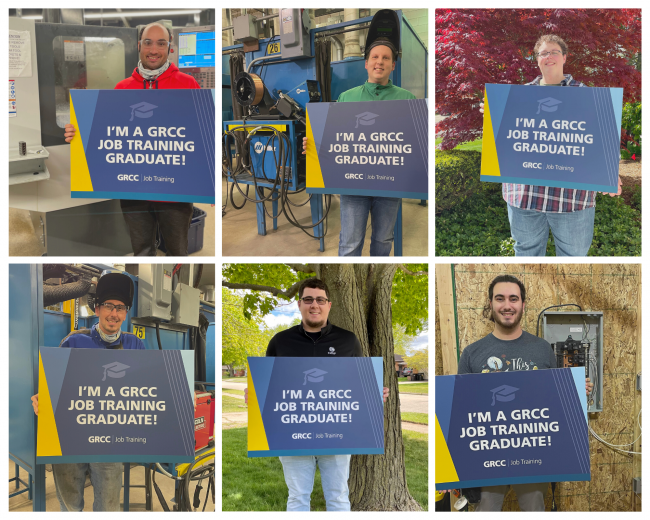 Recent Job Training grads posing with signs.