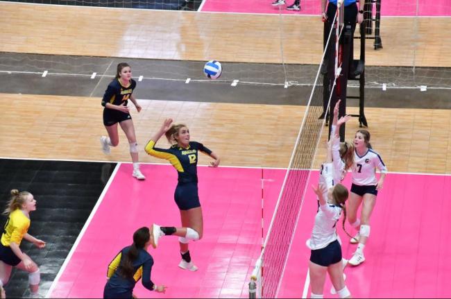 Grand Rapids basketball player leaping to return a shot.