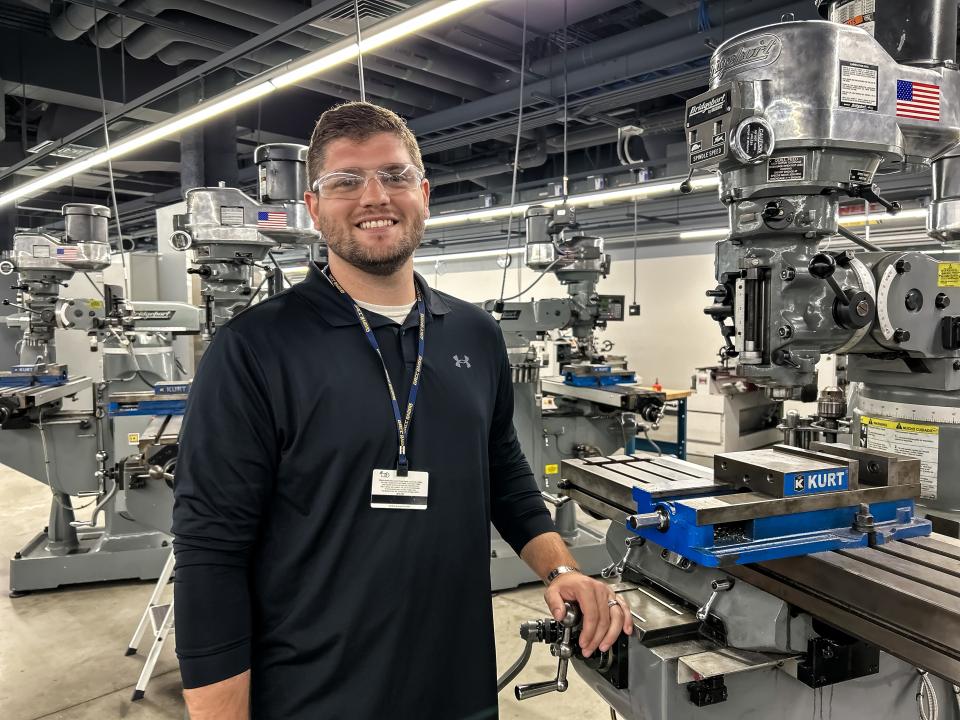 Jake Nichols poses with machinery.