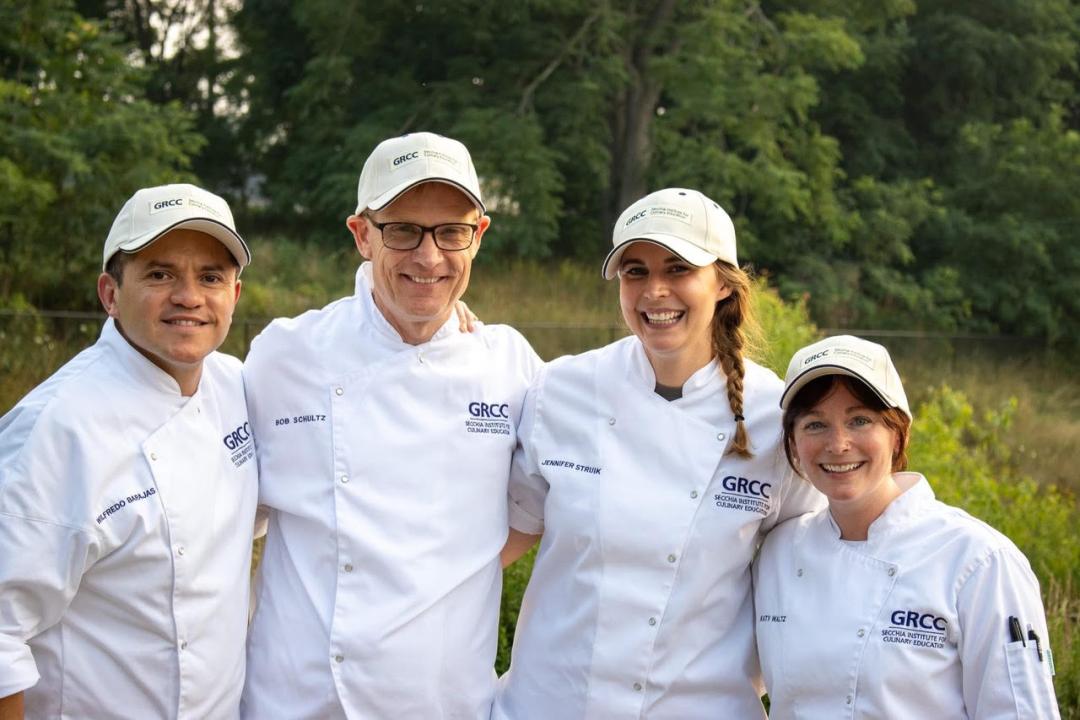 For people in GRCC culinary attire pose together.