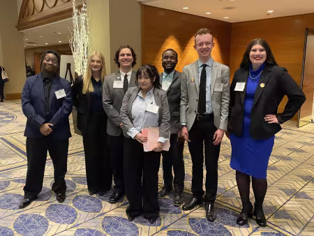 GRCC graduate Zach Danevicz poses with a group of people at the Model U.N.
