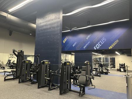 Exercise equipment in a room featuring GRCC-branded wall word art