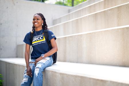 Student sitting outside the library