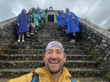 Students on a Study Away program tip pose on a staircase for a group photo.