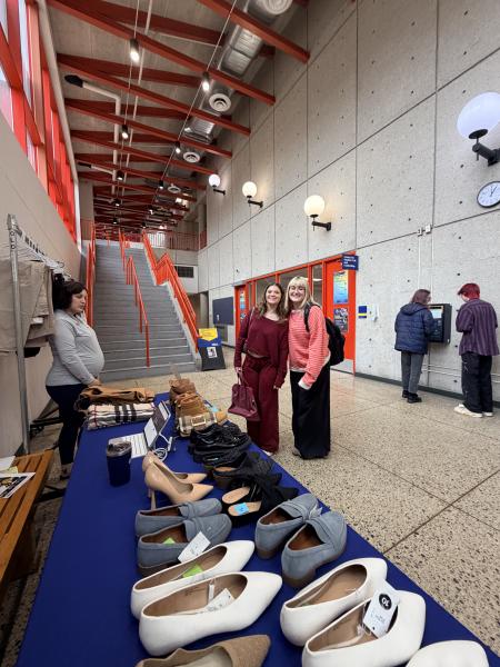 Two students pick out professional clothing at the clothing pop-up.