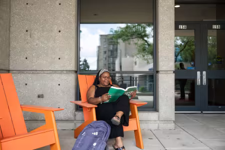 A student sits outside and studies.