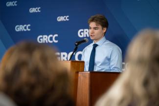 A person speaks at a podium.