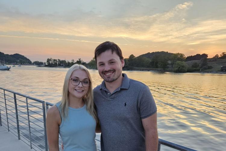 GRCC Job Training program graduate Wyatt Suchecki poses outside near water with his wife.