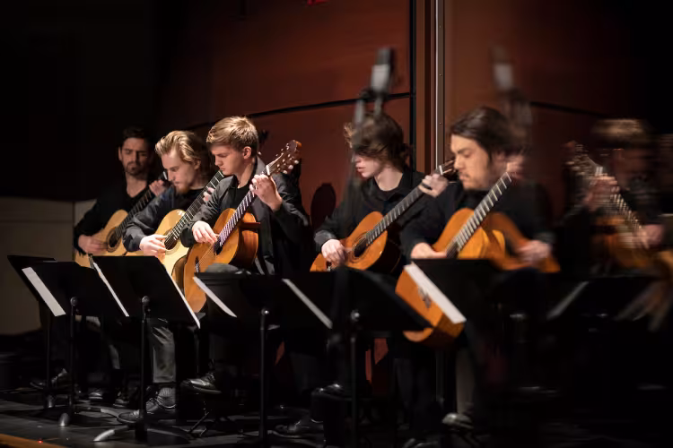GRCC students rehearse with their instruments prior to a performance.