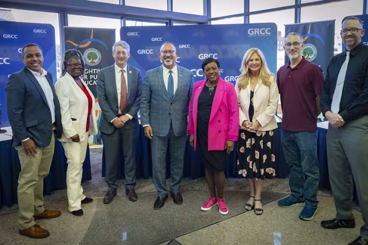 U.S. Secretary of Education Miguel Cardona poses for a photo with other participants of a roundtable talk.