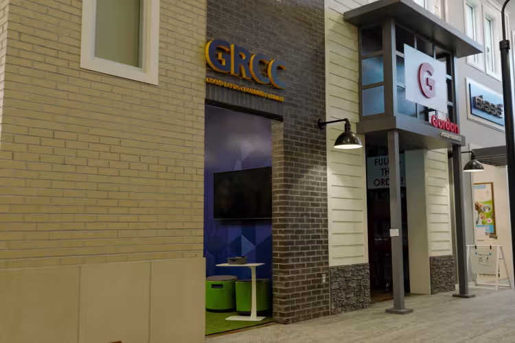 Miniature storefronts featuring GRCC and Gordon Food Service signs.