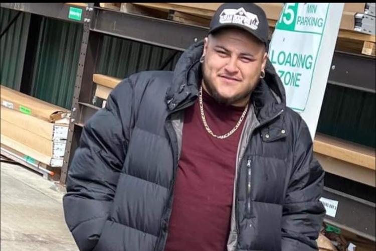 GRCC Job Training Program alumnus Victor Duran stands outside in lumberyard.