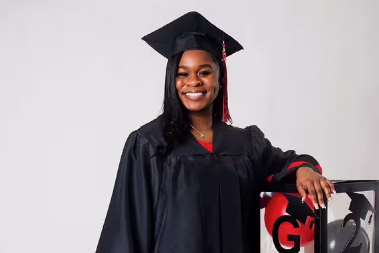 GRCC student Jada Swan poses in a black graduation cap and gown.