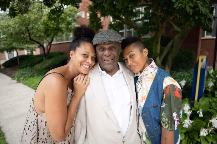 GRCC alumnus Dr. Orzie Henderson poses with two others on Main Campus.