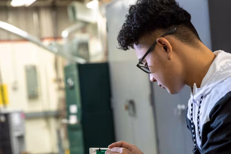 A GRCC student studies HVACR technology.