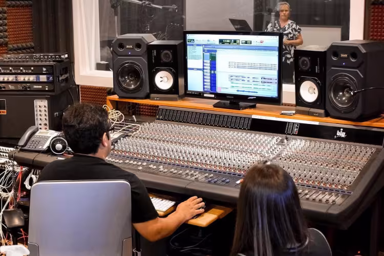 Austin Rustorpher working with an artist at River City Studios.