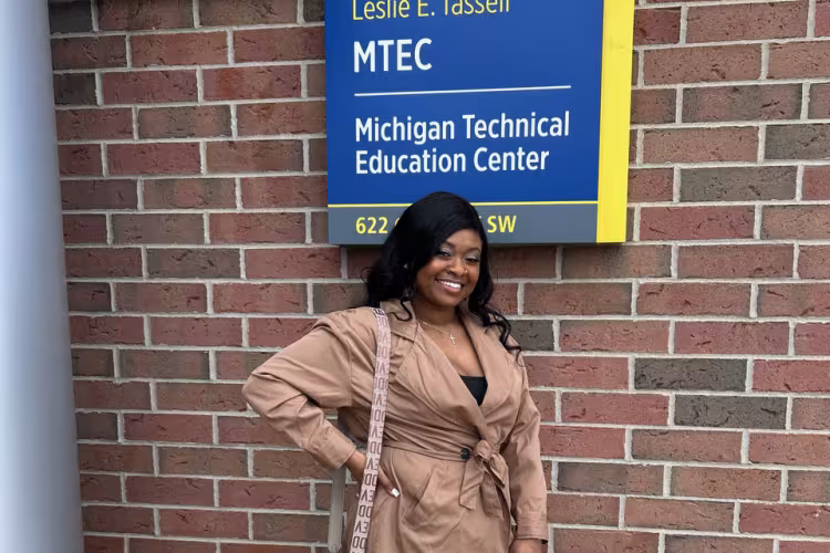 Juané Lancaster stands in front of the GRCC Leslie E. Tassell Michigan Technical Education Center