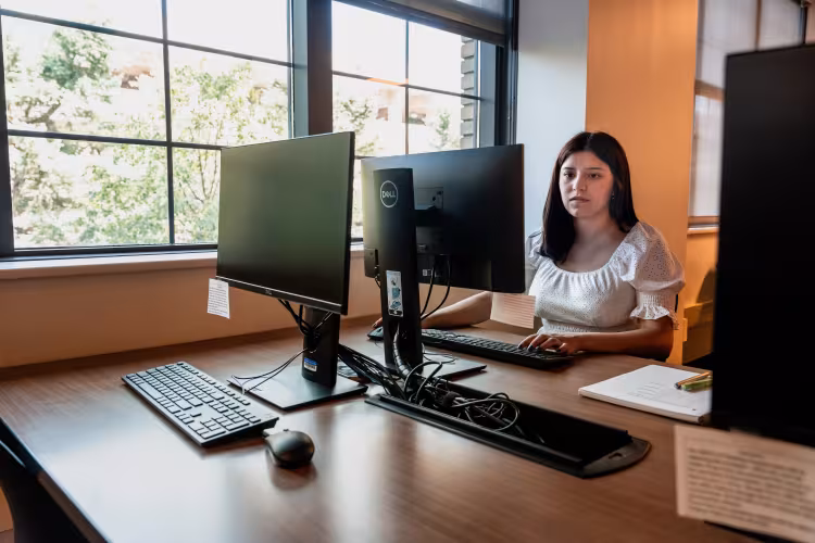 A student works at a computer.