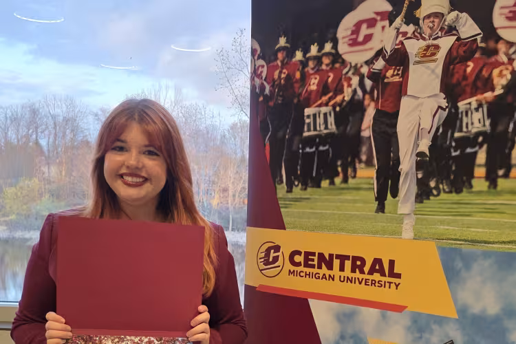 Karalynn Davis holds up her scholarship award.