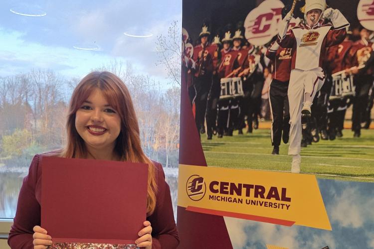 Karalynn Davis holds up her scholarship award.