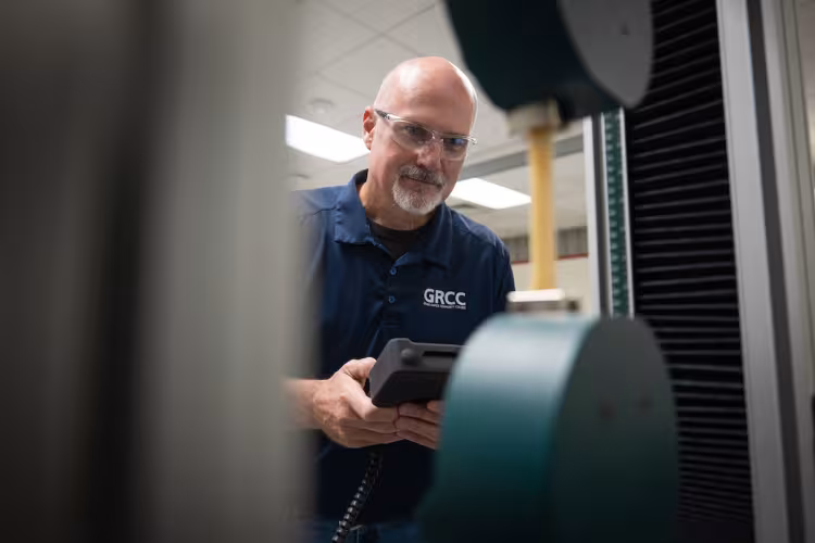 Chris McDonald, a professor in the Quality Science program, works with equipment in a lab.