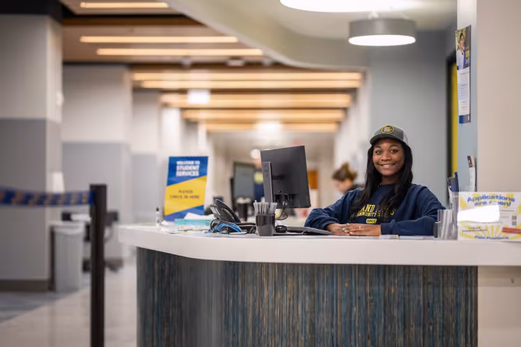 A employee in the enrollment center ready help students start or restart their college degree.