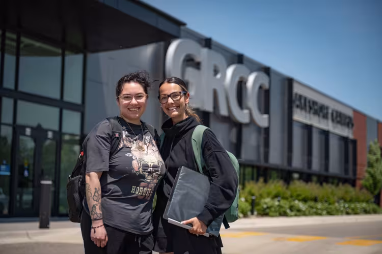 Two students stand outside the Lakeshore campus.
