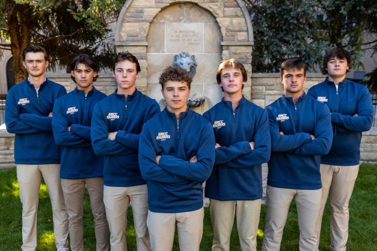 GRCC golf team members standing near the iconic lion fountain.
