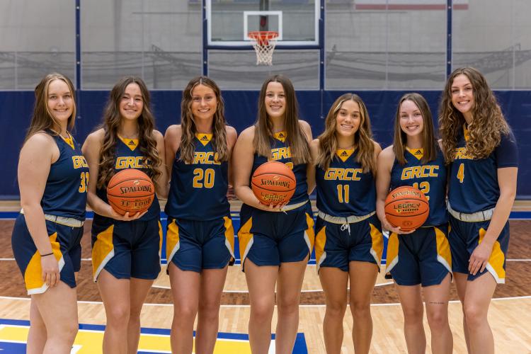 Members of the women's basketball team posing in a row. 