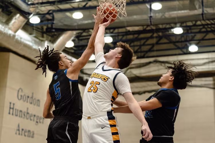Alex Ehnis making a basket during a basketball game