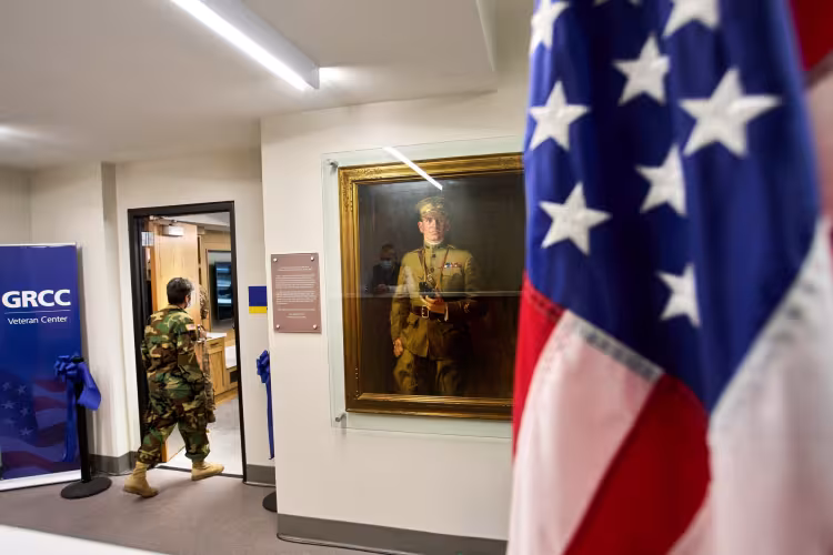A veteran passing the Mathias Alten portrait at the GRCC Veterans Center.