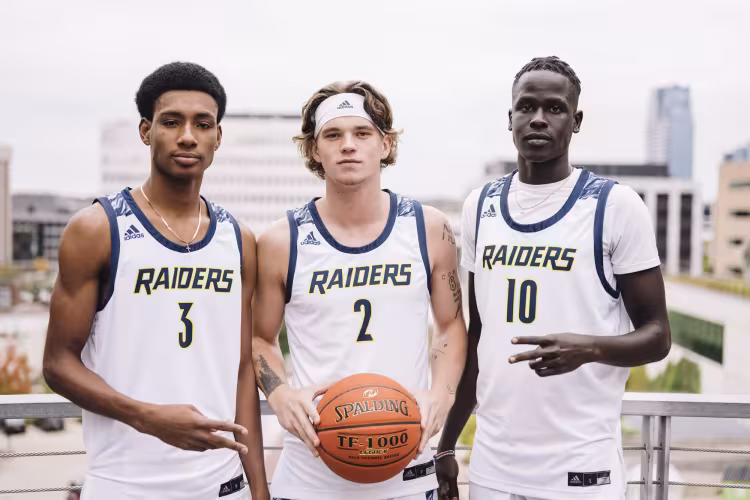 Several basketball players posing for a portrait.