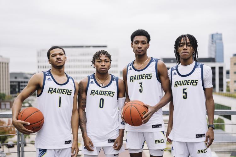 Men's team members posing with a basketball.