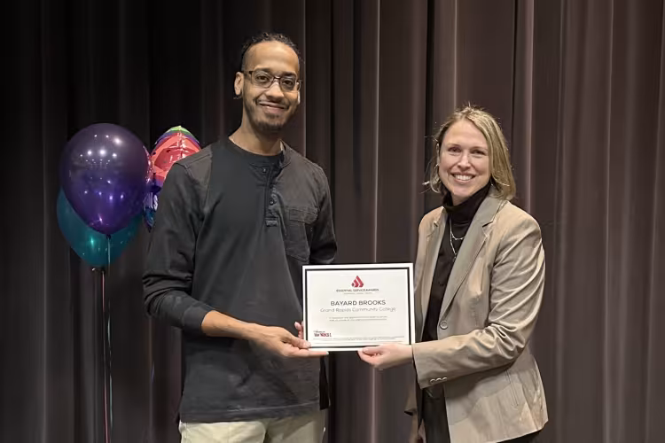 Bayard accepting his award from Malinda Powers.