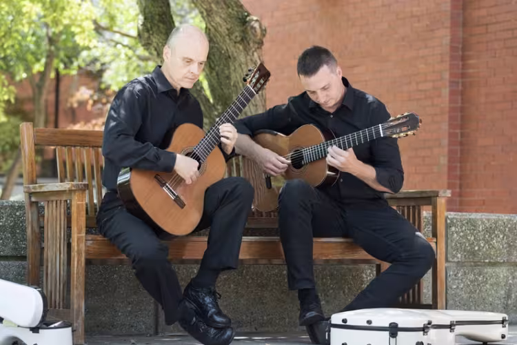 GRCC guitar instructors Brian Morris and Jonathan Marshall practicing outside.