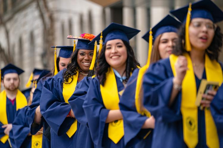 Students in caps and gowns at commencement.