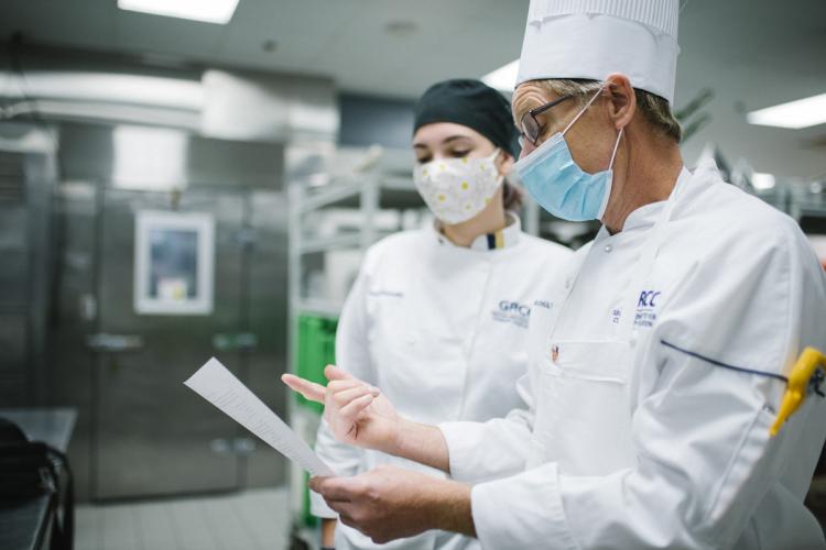 Chef Bob Schultz working with a student.