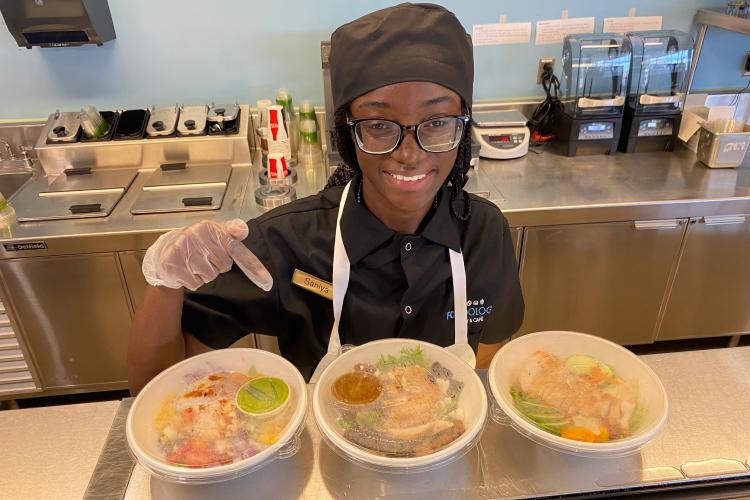 A Secchia Institute students points out healthier options in Foodology.